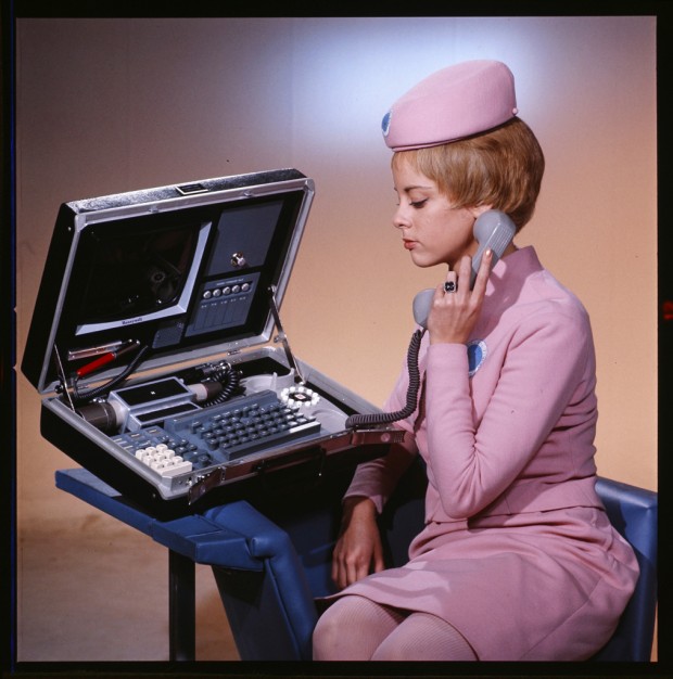 In this production photo from 2001: A Space Odyssey, a space stewardess is seen elegantly using a portable videophone. If the blue, circle badge on her uniform is any indication she’s stationed, in the film, at Clavius Base which served as a Research Center when the first monolith was discovered on the Moon.