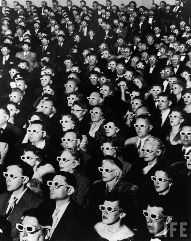 Caption from LIFE: 3-D Movie Viewers. Formally attired audience sporting 3-D (3D) glasses during opening night screening of movie "Bwana Devil," the 1st full length, color 3-D (aka "Natural Vision") motion picture, at Paramount Theater, Hollywood, CA. Photo by J.R. Eyerman, 1952